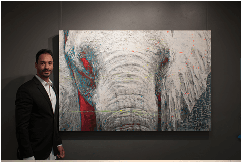 Brandon Jameson standing next to his work