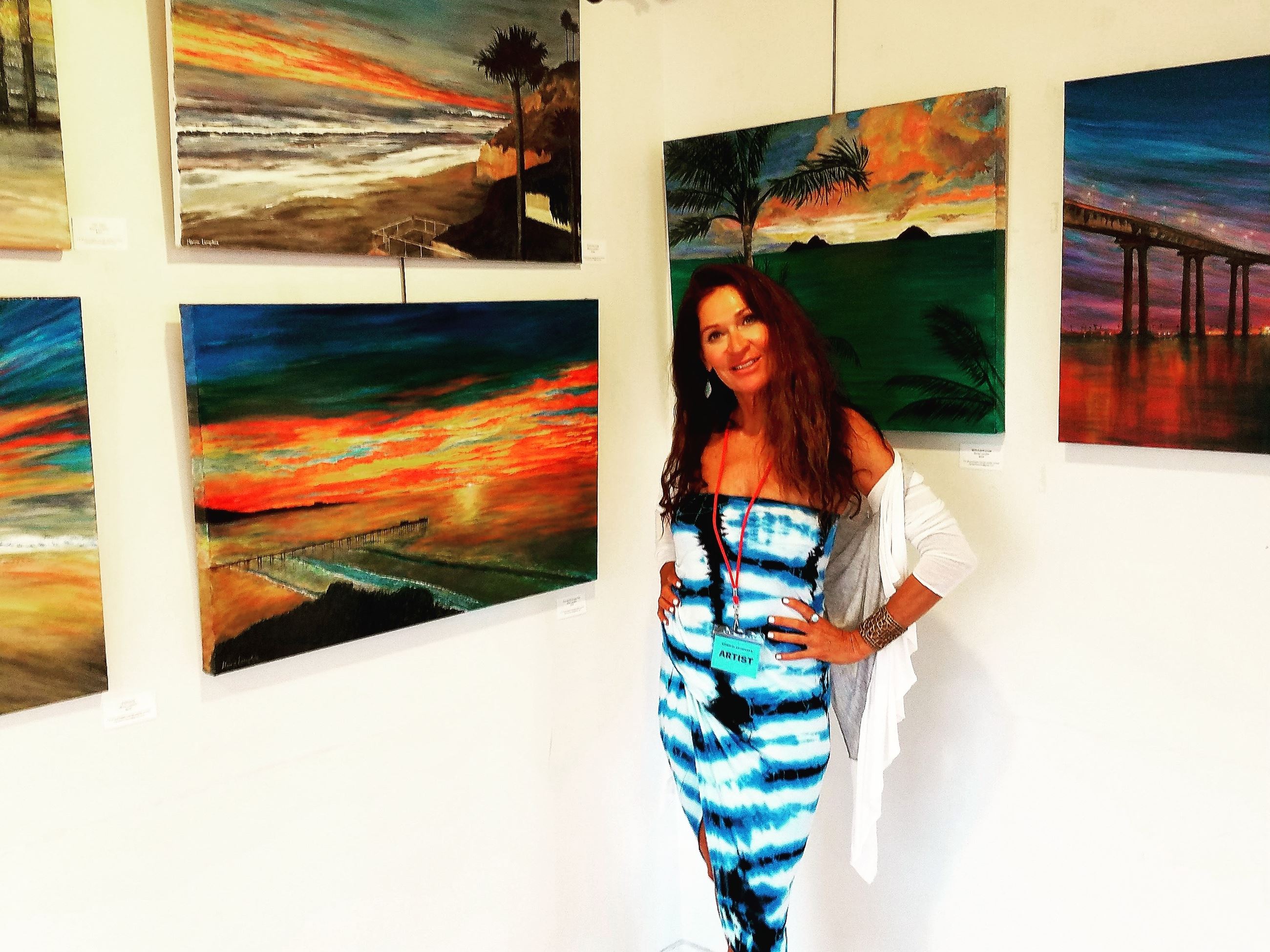 Moira Lumpkin in front of a few of her pieces